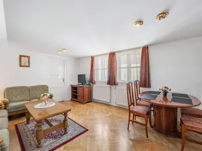 a living room with a table and a couch at Apartment Old Town home-5 by Interhome in Prague