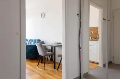 a living room with a table and a mirror at National Museum View Studio in Prague