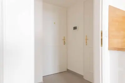a hallway with two white doors in a room at National Museum View Studio in Prague