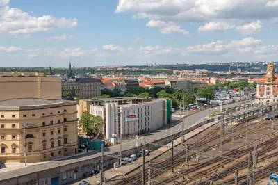 a view of a city with train tracks and buildings at National Museum View Studio in Prague