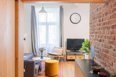 a living room with a brick wall at Prague Days - Studio with Netflix and Apple TV next to Park in Lesser Town in Prague