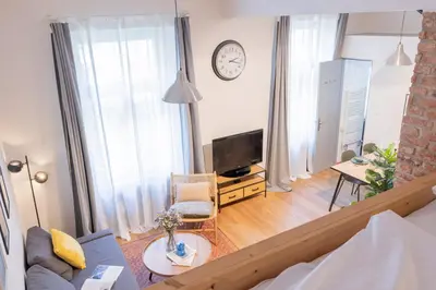 a living room with a couch and a tv at Prague Days - Studio with Netflix and Apple TV next to Park in Lesser Town in Prague