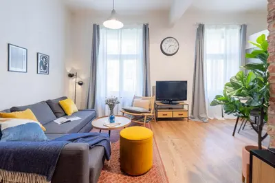a living room with a couch and a tv at Prague Days - Studio with Netflix and Apple TV next to Park in Lesser Town in Prague