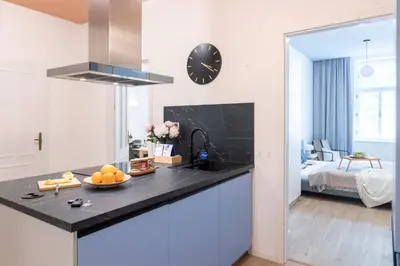 a kitchen with a counter top with a clock on the wall at Prague Days - 3BDR Apartments with Terrace in Residential Vinohrady in Prague