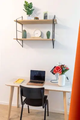 a desk with a laptop computer on top of it at Prague Days - 3BDR Apartments with Terrace in Residential Vinohrady in Prague