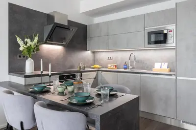 a kitchen with a table with dishes on it at Prague Days - Modern Apartment with Terrace and AC in Karlín in Prague