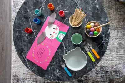 a table with a pink napkin and a bowl of eggs at Prague Days - Modern Apartment with Terrace and AC in Karlín in Prague