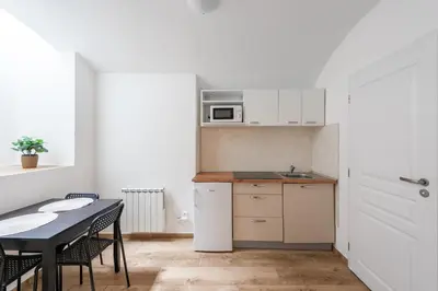 a small kitchen with a table and a microwave at Milano Apartment in Prague