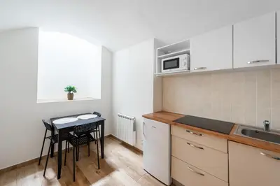 a small kitchen with a table and a microwave at Milano Apartment in Prague