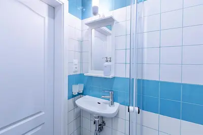 a bathroom with a sink and a shower at Charming Apartment in Historic Old Town in Prague