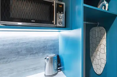 two photos of a microwave and a toaster oven at Charming Apartment in Historic Old Town in Prague