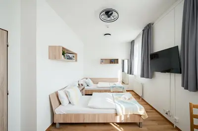 a room with two beds and a table in it at University Hotel in Prague