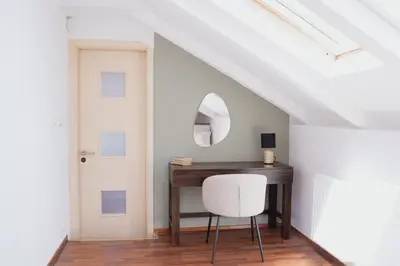a white room with a desk and a white chair at bohemian symphony in Prague