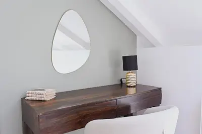 a dressing table with a mirror and a white chair at bohemian symphony in Prague