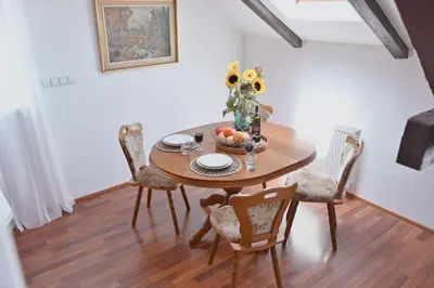 a dining room table with a vase of flowers on it at bohemian symphony in Prague