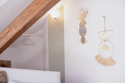 a living room with white walls and a wooden ceiling at bohemian symphony in Prague