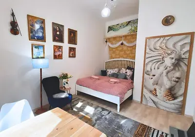 a bedroom with a bed and a wall with pictures at AUTHENTIC Vyšehrad-2BR-Near CONGRES center-Riverside to the center in Prague