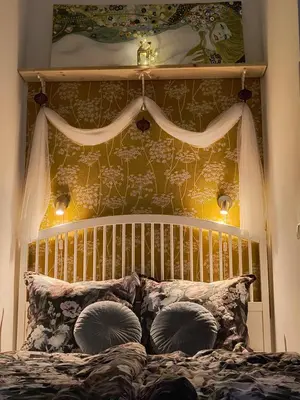 a bed with a wooden headboard and pillows at AUTHENTIC Vyšehrad-2BR-Near CONGRES center-Riverside to the center in Prague