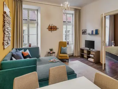 a living room with a couch and a tv at 4 Arts Apartments by Adrez in Prague