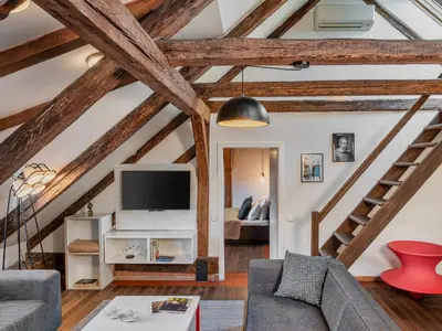 a living room with wooden beams at 4 Arts Apartments by Adrez in Prague
