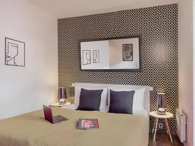 a bedroom with a bed with a laptop on it at 4 Arts Apartments by Adrez in Prague