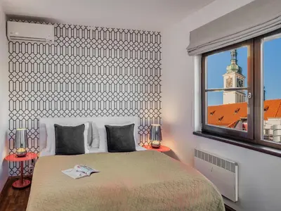 a bedroom with a large bed and a window at 4 Arts Apartments by Adrez in Prague