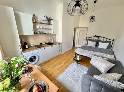 a living room with a bed and a couch at Beautiful apartment near Muzeum in Prague
