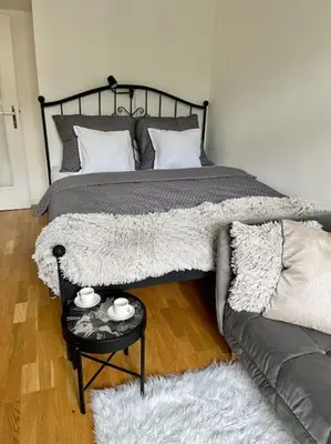a bedroom with a bed and a couch and a table at Beautiful apartment near Muzeum in Prague