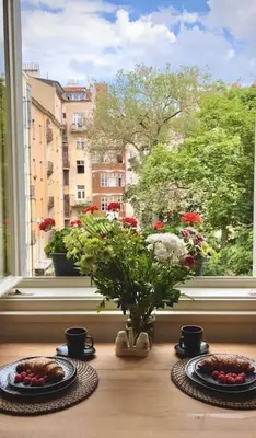 two plates of food on a table in front of a window at Beautiful apartment near Muzeum in Prague