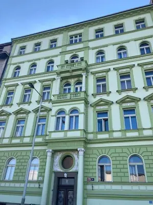a large green building with windows and a door at Beautiful apartment near Muzeum in Prague