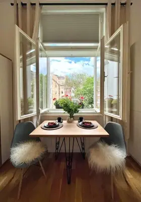 a table with two chairs in front of a window at Beautiful apartment near Muzeum in Prague