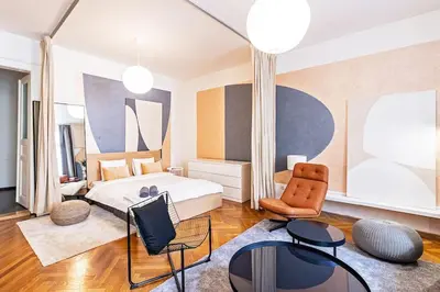 a hotel room with a bed and a chair at Unique stylish apartment - L3 in Prague