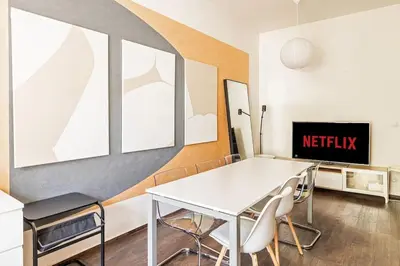 a dining room with a white table and chairs at Unique stylish apartment - L3 in Prague