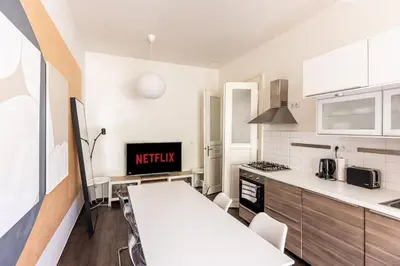 a kitchen with a table and a counter top at Unique stylish apartment - L3 in Prague