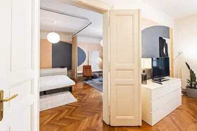 a room with a bed and a tv and a door at Unique stylish apartment - L3 in Prague