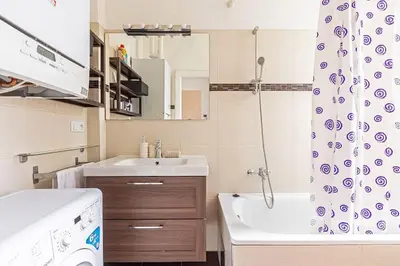a bathroom with a sink and a shower curtain at Unique stylish apartment - L3 in Prague