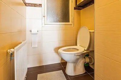 a bathroom with a white toilet in a room at Unique stylish apartment - L3 in Prague