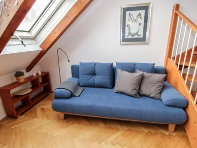 a blue couch in a living room with a staircase at Apartment O21 by Interhome in Prague