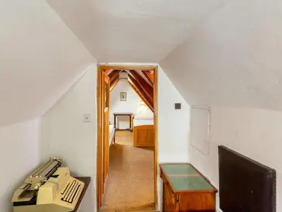 an attic room with an office with a desk and a mirror at Apartment Prague Castle Duplex by Interhome in Prague