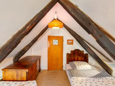 a attic room with two beds and a window at Apartment Prague Castle Duplex by Interhome in Prague