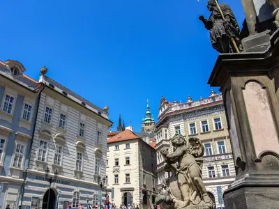 a statue in the middle of a city with buildings at Apartment Prague Castle Duplex by Interhome in Prague