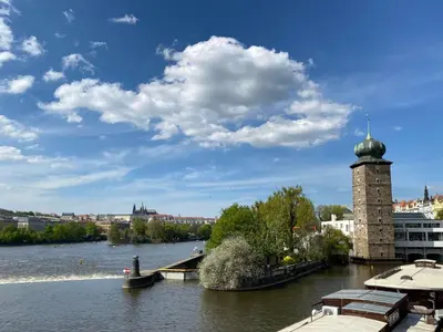 a view of a river with a clock tower at Apartment Prague Castle Duplex by Interhome in Prague
