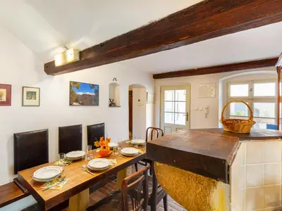 a dining room with a wooden table and chairs at Apartment Prague Castle Duplex by Interhome in Prague