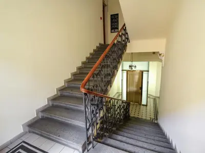 a staircase in a building with a metal railing at Apartment Manes Residence by Interhome in Prague