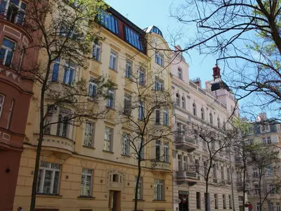 a large yellow building with trees in front of it at Apartment Manes Residence by Interhome in Prague