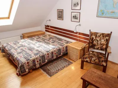 a bedroom with a bed and a chair at Apartment Hodkovičky by Interhome in Prague