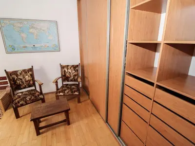 a room with two chairs and a book shelf at Apartment Hodkovičky by Interhome in Prague