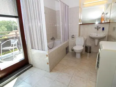 a bathroom with a tub and a toilet and a sink at Apartment Hodkovičky by Interhome in Prague