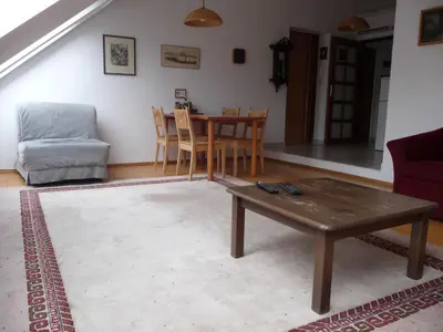 a living room with a table and a chair at Apartment Hodkovičky by Interhome in Prague