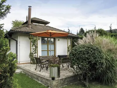 a house with a patio with an umbrella at Villa Petříkov by Interhome in Petříkov